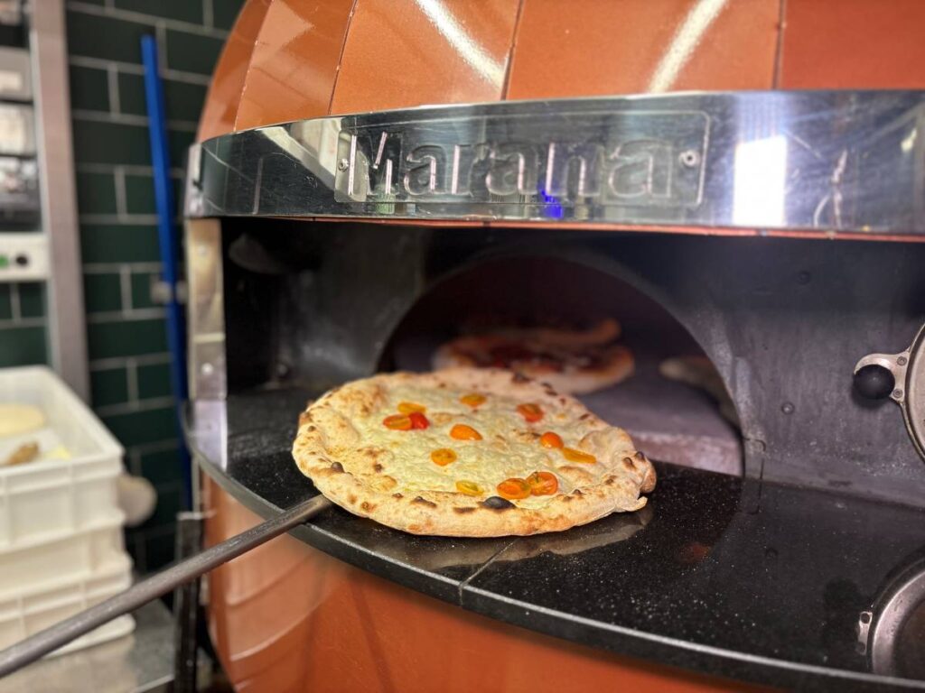 Orange and chrome pizza oven in stockport